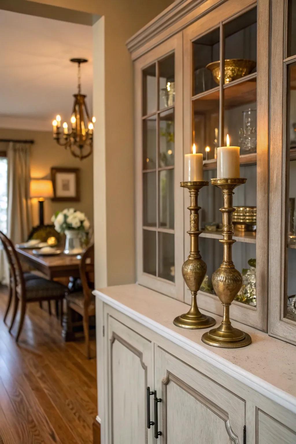 A dining room hutch featuring metallic accents like brass candlesticks for a touch of luxury.