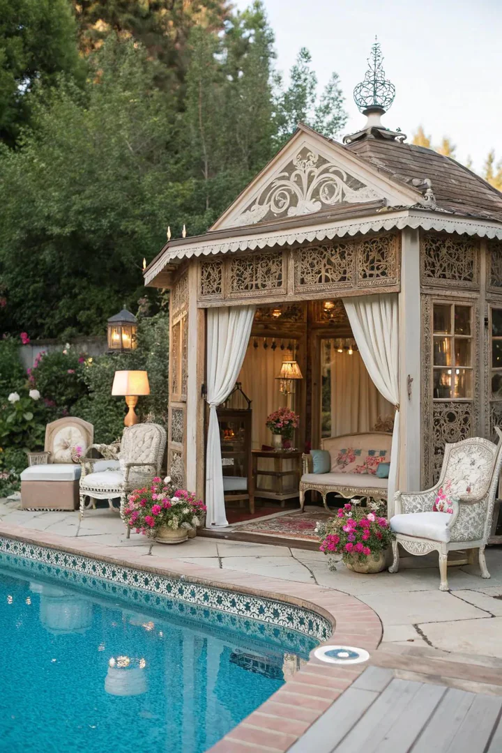 Glamorous poolside cabana with plush curtains, a chandelier, and mirrored accessories