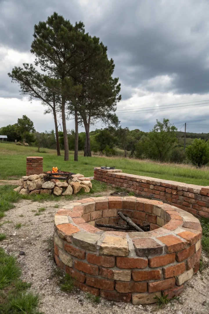 Irregularly shaped brick fire pit with one tall side and one low side