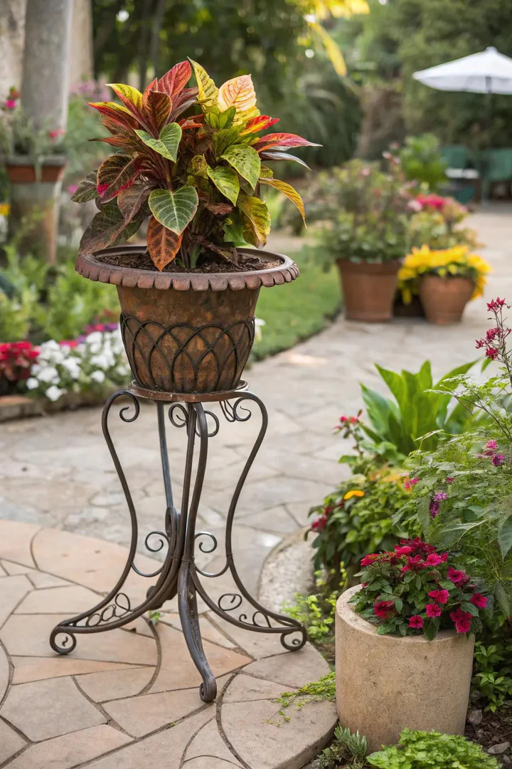 Welded iron plant stand with curved legs and a ring top for holding pots