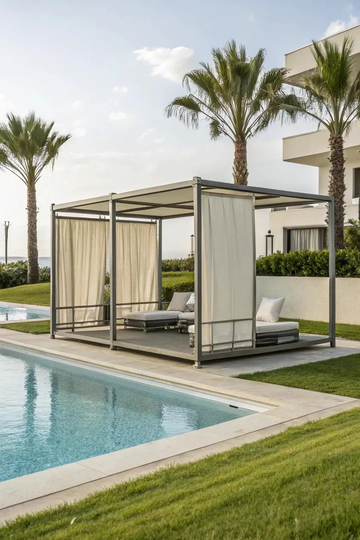 Sleek modern pool cabana with clean lines, flat roof, and white curtains